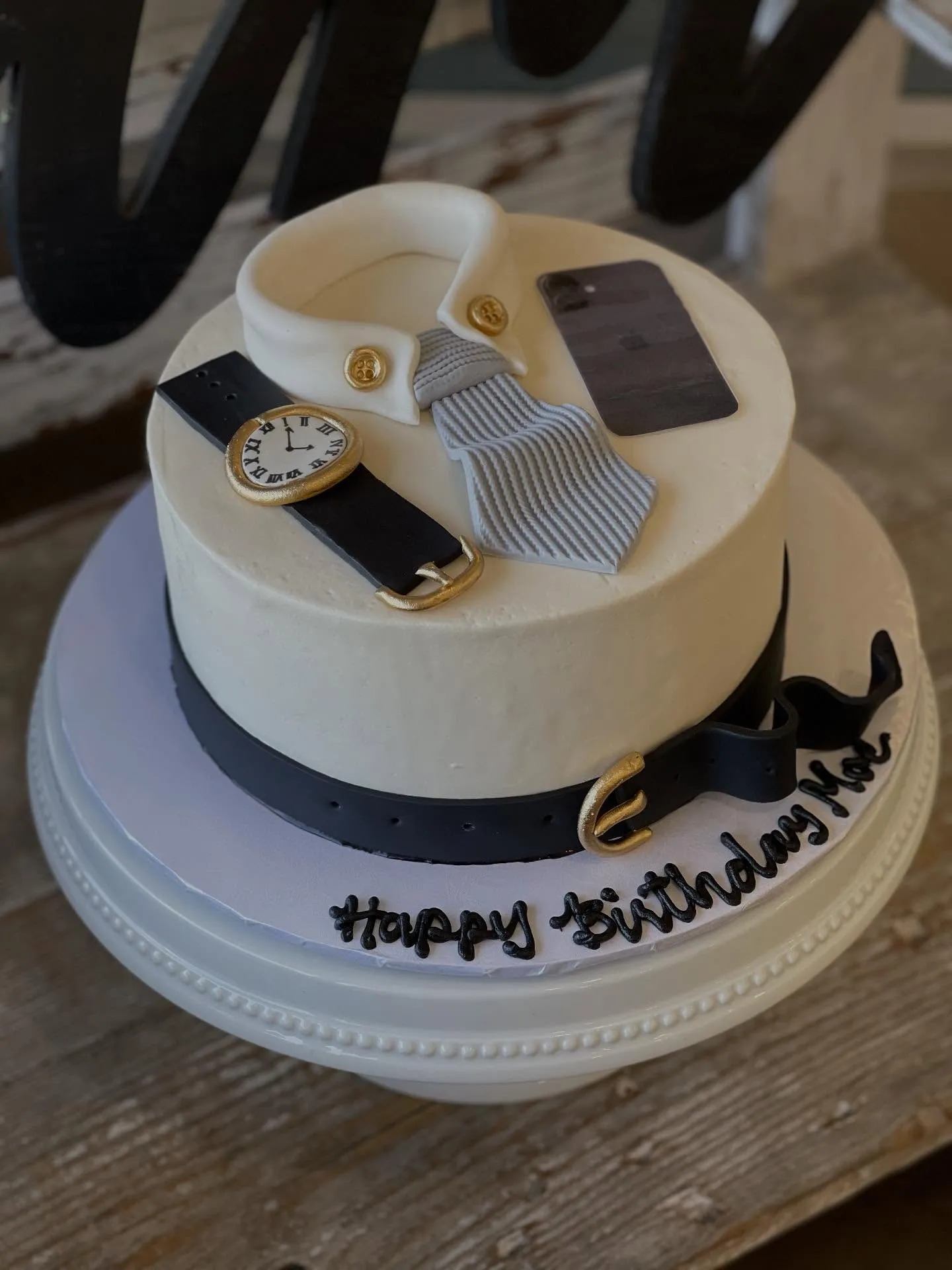 Whimsical themed birthday cake with fondant decorations, creative bakery design